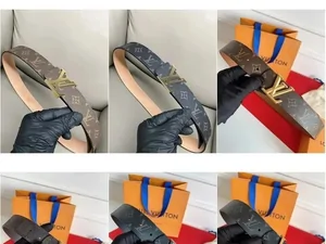 Several belts with metal buckles laid out in rows