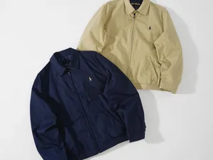 A navy and a beige zip jacket laid side by side
